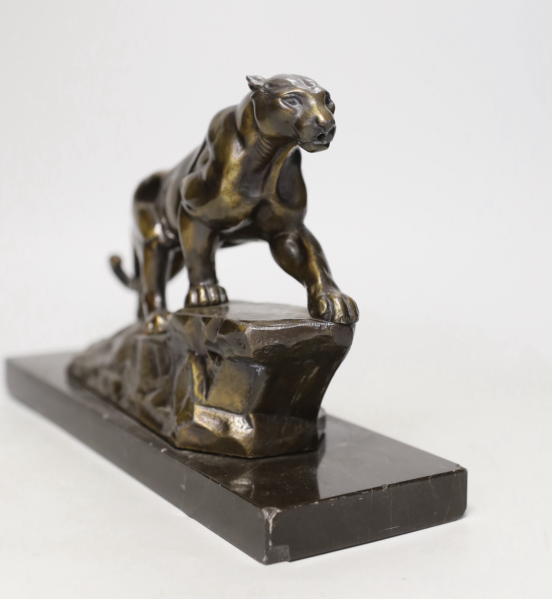 A French Art Deco spelter model of a panther, on marble base, 28cm long